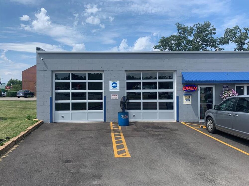Commercial auto shop with full-view glass overhead doors