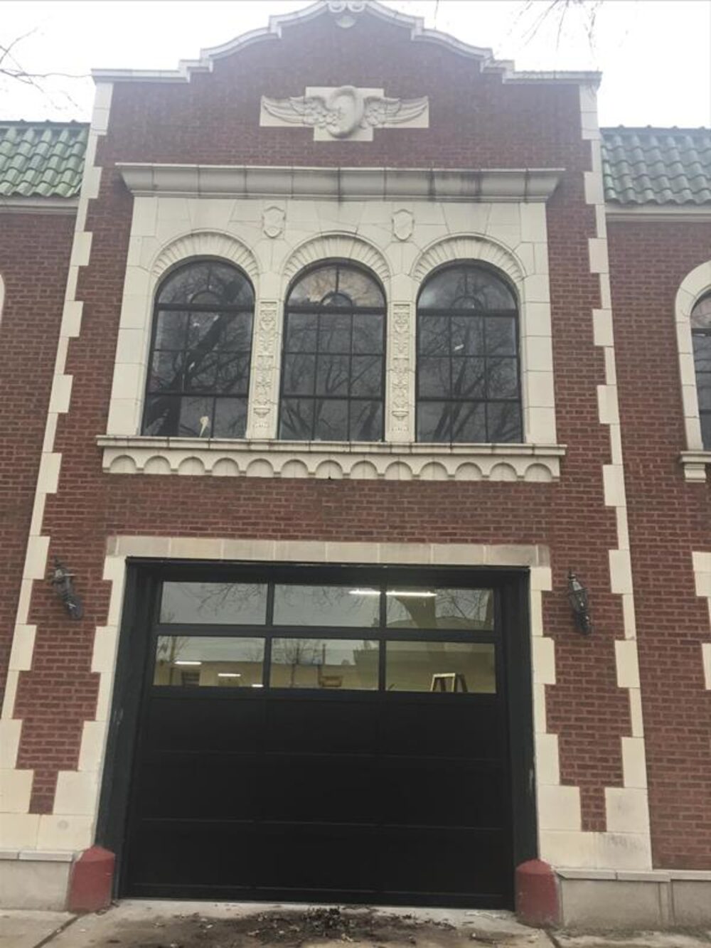 Full-view glass overhead door on a historic brick building