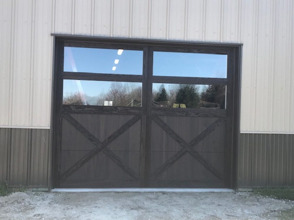 Dark full-view glass overhead door on a metal building