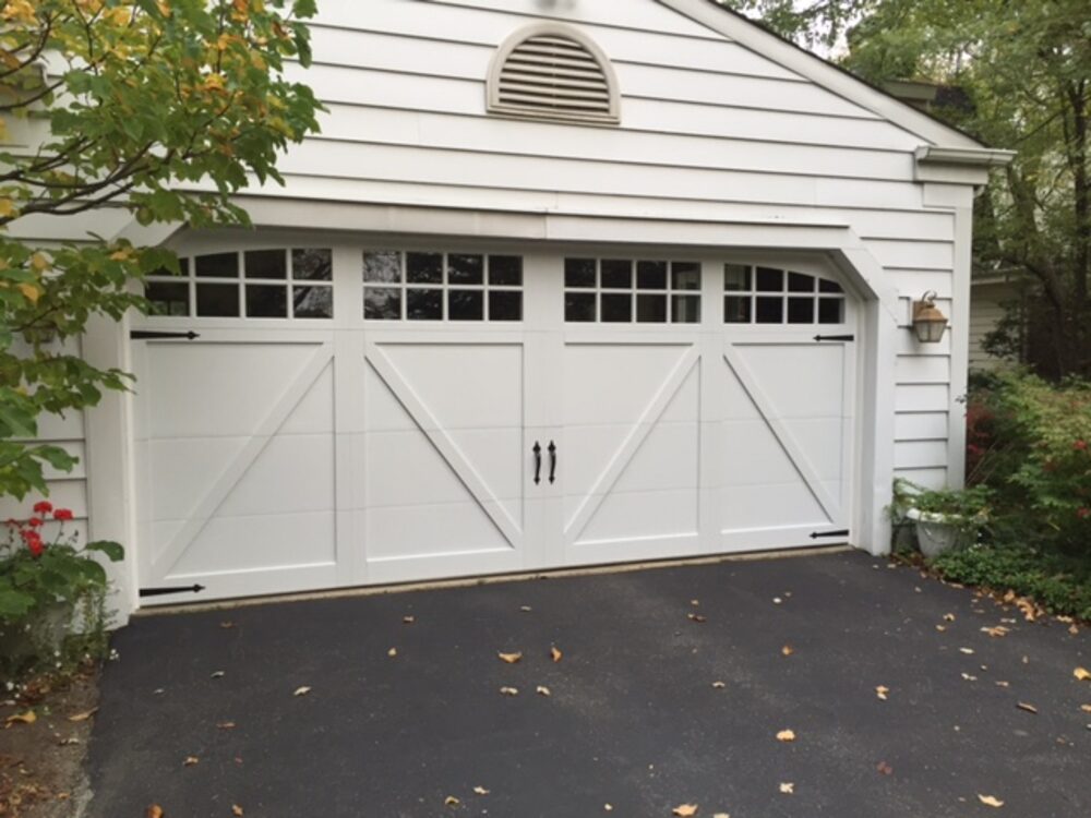 White carriage-house double door on a suburban home