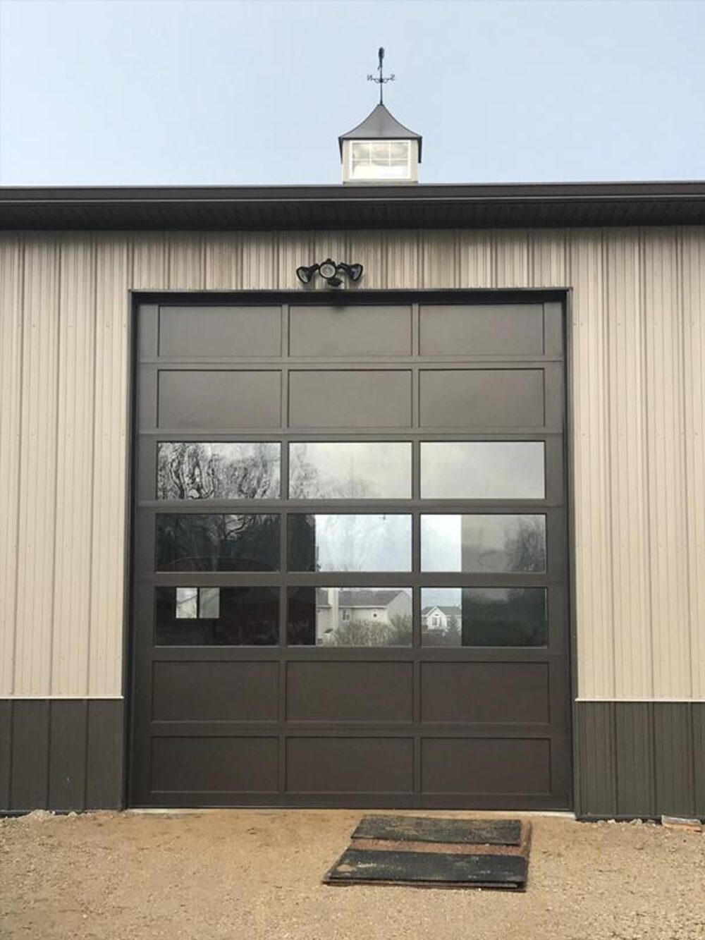 Full-view glass overhead door on a metal commercial building