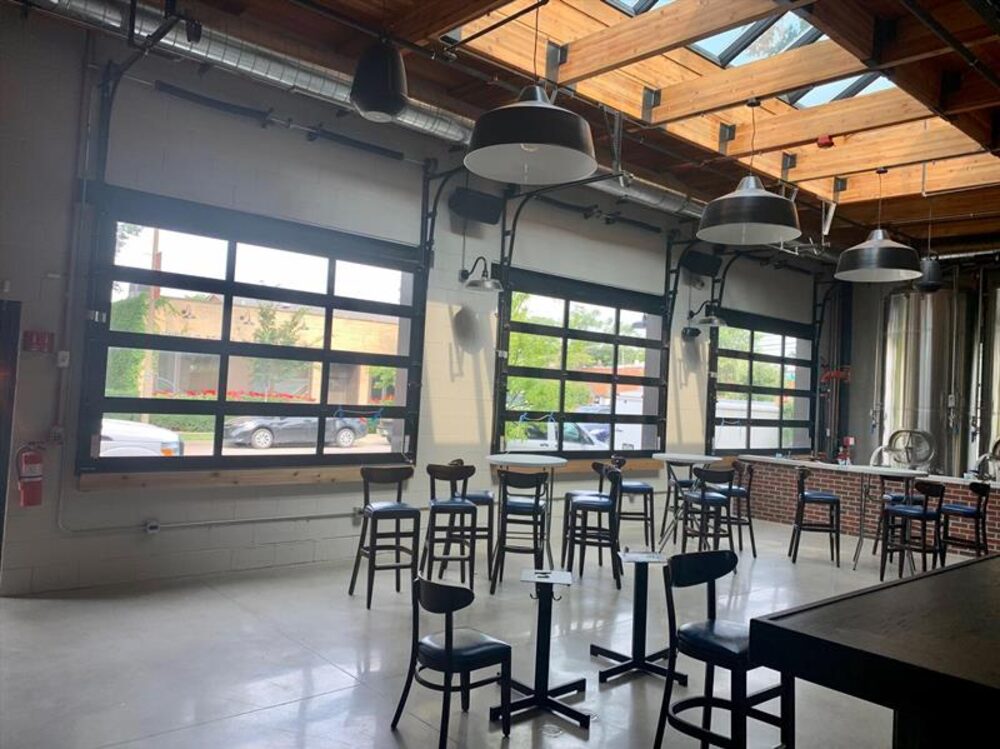Brewery taproom with full-view glass overhead doors